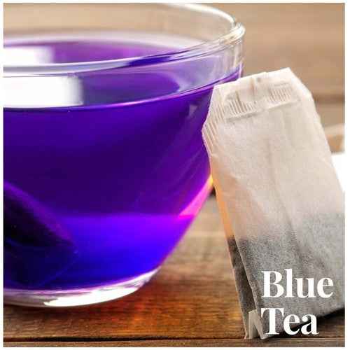Cup of vibrant blue butterfly pea flower tea caffeine free with a tea bag on wooden surface