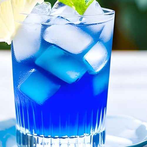 Iced butterfly pea flower tea caffeine free served in a clear glass with ice and mint garnish