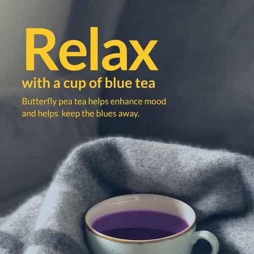 Cup of butterfly pea flower tea caffeine free with calming blue color on cozy gray blanket