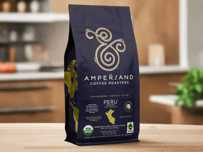 DC-Ampersand Coffee Roasters Peru Fair Trade Organic Coffee bag in black with gold logo on wooden table