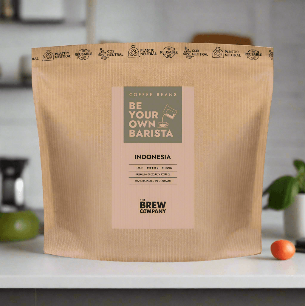 The Brew Company bag of organic Indonesian coffee beans with eco-friendly packaging on kitchen counter