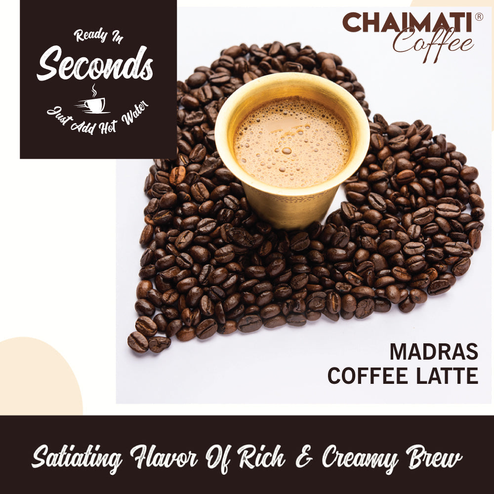 Chaimati premium coffee Madras coffee latte with creamy froth surrounded by coffee beans in a heart shape