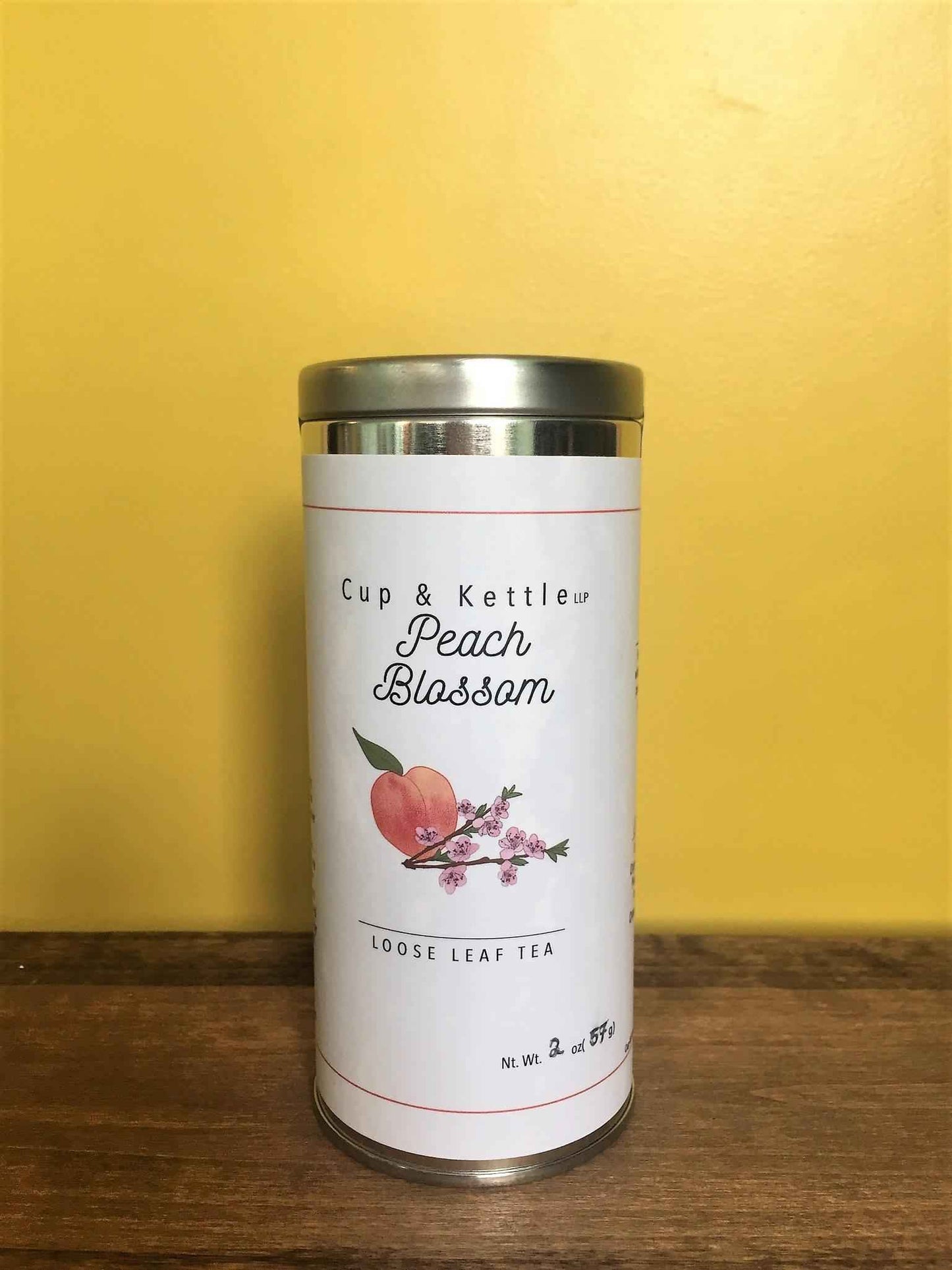 DC-Cup & Kettle Tea Peach Blossom Loose Leaf Tea in a white cylindrical tin with silver lid