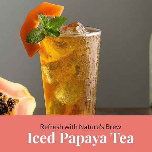 Iced organic papaya leaf tea garnished with papaya slice and mint leaves from Tea & coffee of the world