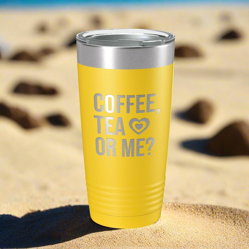 Yellow eco-friendly coffee tumbler by CarveBright with silver lid and coffee tea or me text on sand background
