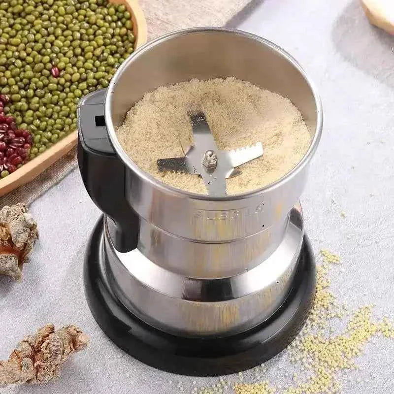 Electric spice and coffee grinder in stainless steel with freshly ground powder inside by Tea and Coffee of the World