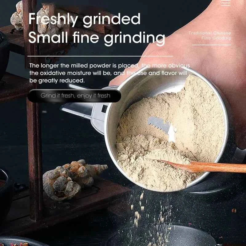 Electric spice and coffee grinder with freshly ground fine powder being poured out