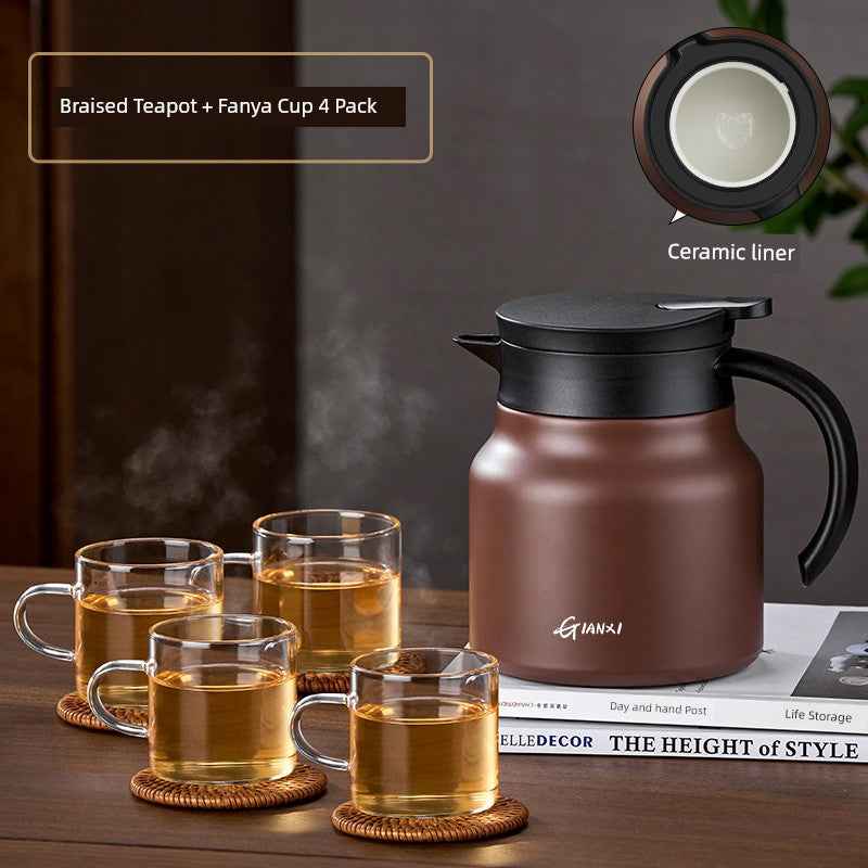 High-quality braised teapot with ceramic liner and four glass cups on coasters on wooden table