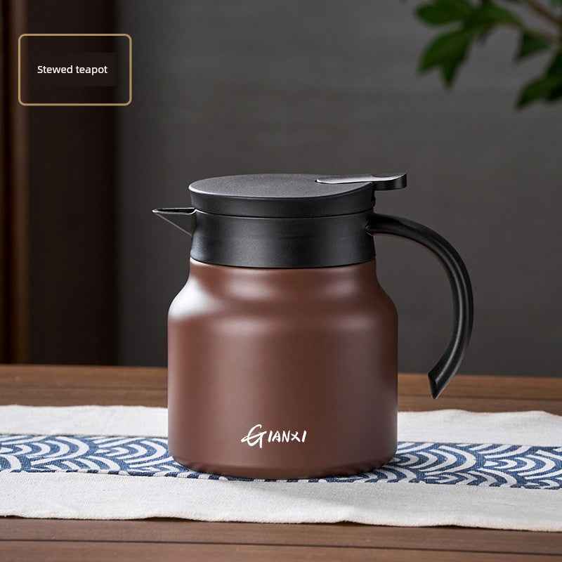 High-quality braised teapot with a black lid and handle on wooden table by Tea and coffee of the world