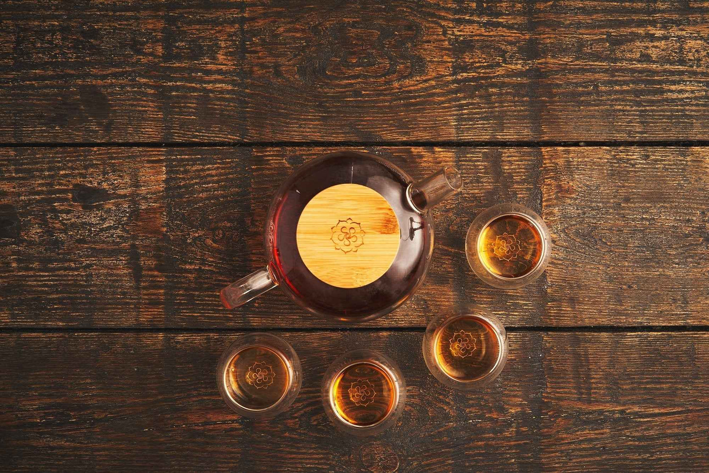 B.TEALY handcrafted glass tea set with wooden lid and four glass cups on wooden table
