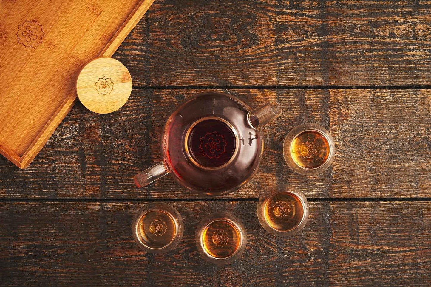 B.TEALY handcrafted glass tea set with teapot and five tea cups on wooden surface