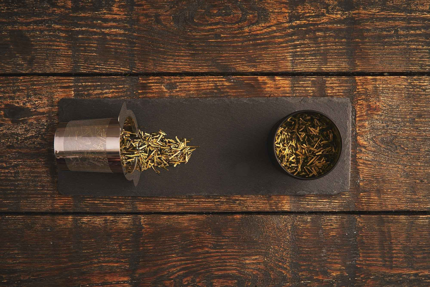 B.TEALY handcrafted tea filter with loose tea leaves on rustic wooden surface