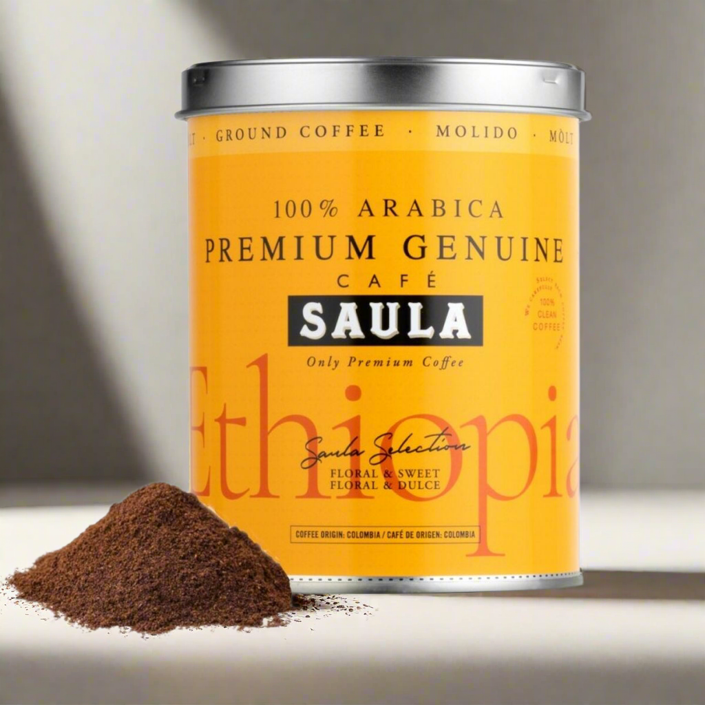 Saula premium Ethiopian ground coffee in bright yellow can with a pile of ground coffee next to it