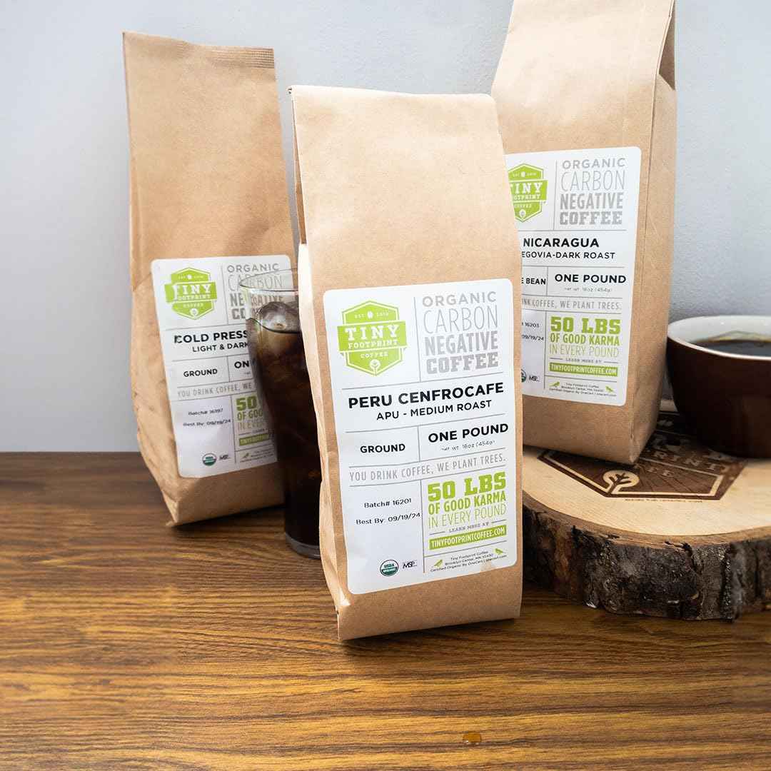 Fair trade organic coffee beans in brown paper bags with labels from Tea and Coffee of the World
