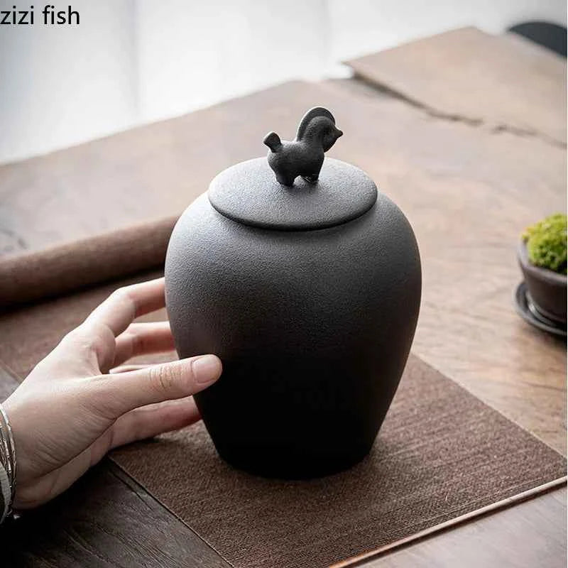 Black sealed tea storage jar with bird-shaped lid handle from Tea & coffee of the world accessories