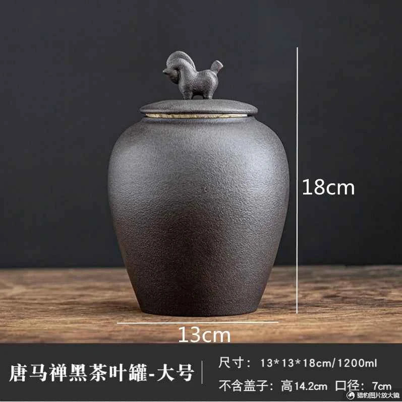 Black sealed tea storage jar with horse-shaped lid, 18cm tall and 13cm wide from Tea & coffee of the world