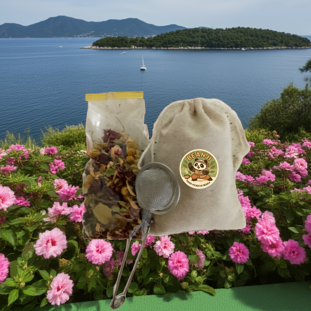Tea & Coffee of the World mint and lemon herbal tea set with dried herbs, infuser, and cloth bag by a floral sea view