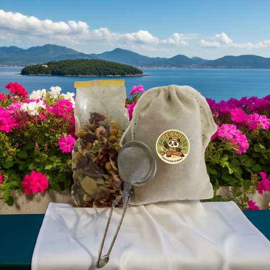 Mint and lemon herbal tea package with tea infuser and pouch by Tea and Coffee of the World against scenic ocean view