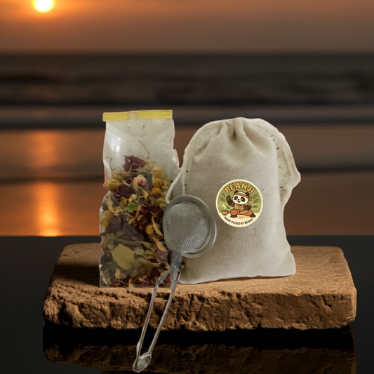 Organic black tea from Granada packaging with tea infuser on wooden board at sunset background