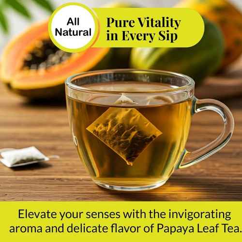 Organic papaya leaf tea brewing in a clear glass cup with fresh papaya fruit in background