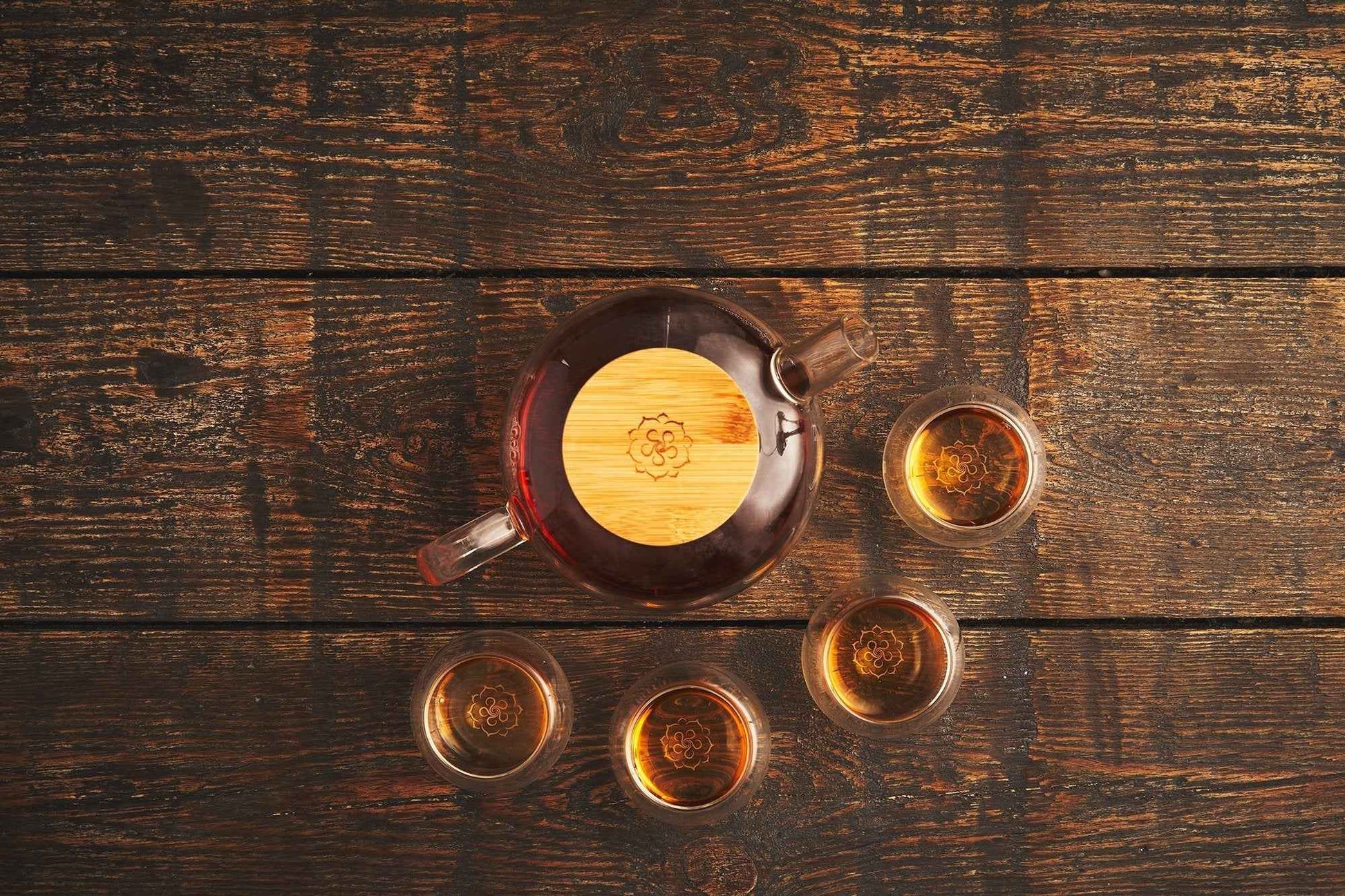B.TEALY handcrafted glass tea set with wooden lid and four glass cups on wooden table