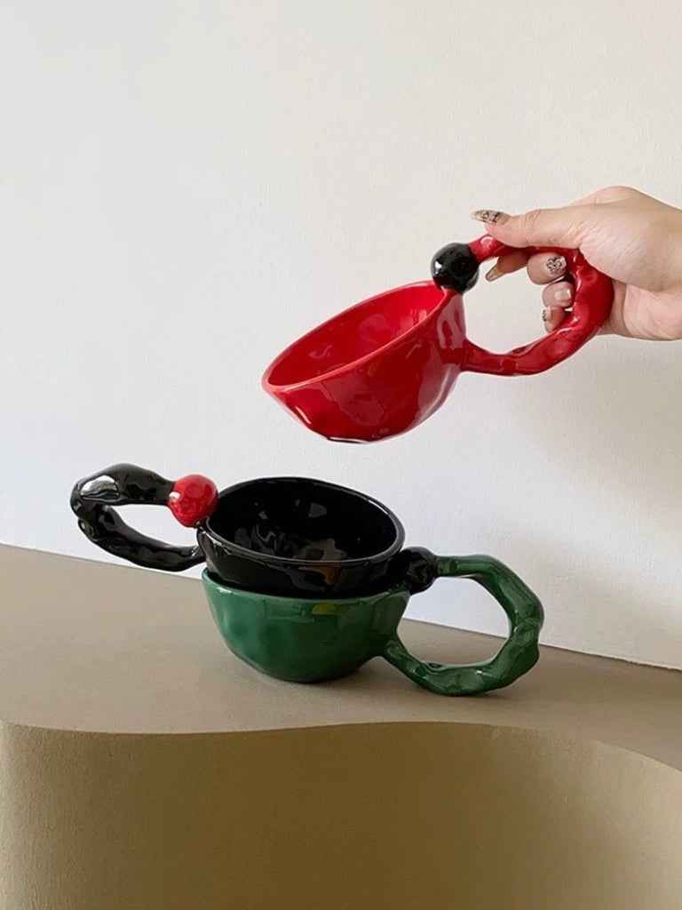 INSPECIAL HOME handmade ceramic coffee mugs in red, black, and green with unique twisted handles