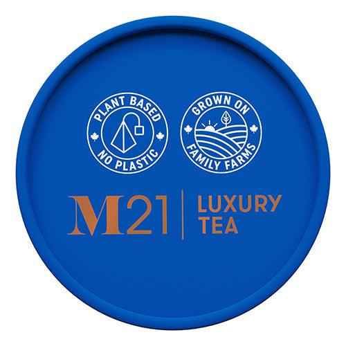 Blue lid of DC-Tega Tea featuring M21 Luxury Tea logo with plant based and family farm icons for Boston Tea Party luxury black tea