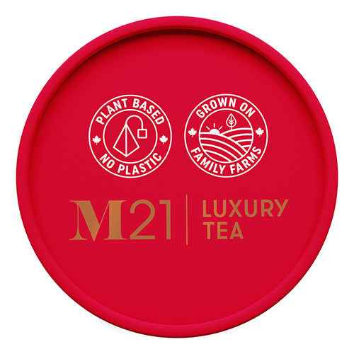 Red round lid of DC-Tega Tea M21 Luxury Tea with Canadian Breakfast Black Tea branding and eco-friendly icons