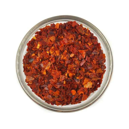 Premium organic chili flakes in a clear glass bowl from Tea & Coffee of the World