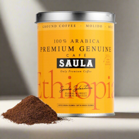 Saula premium Ethiopian ground coffee in bright yellow can with a pile of ground coffee next to it
