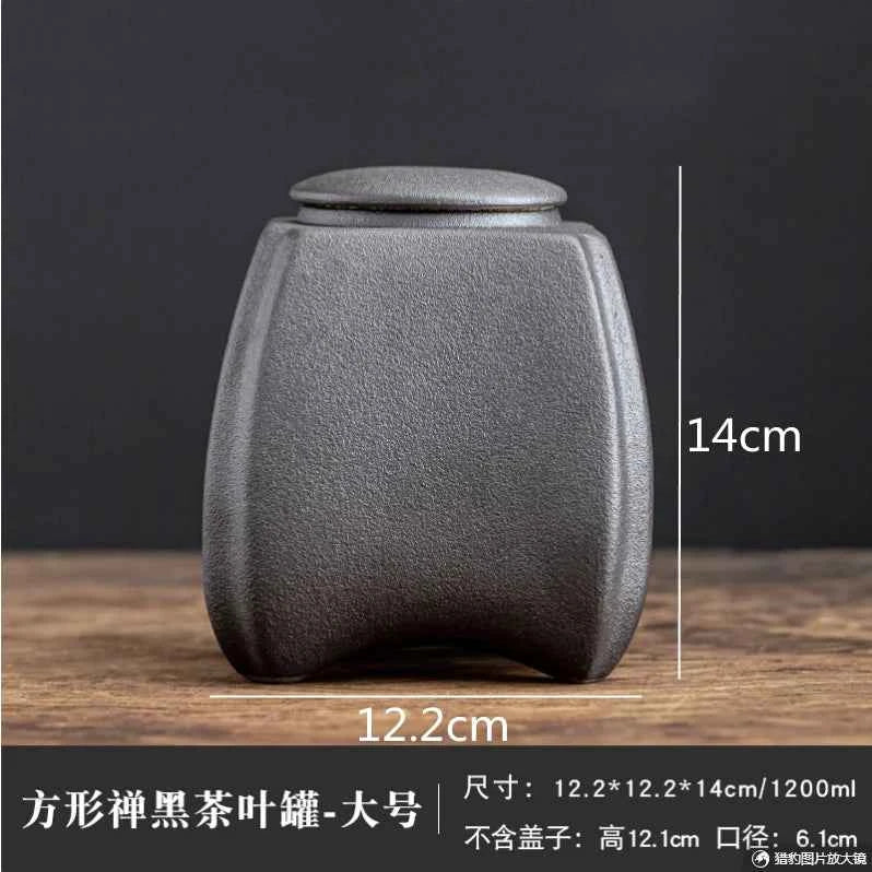 Matte black sealed tea storage jar with textured finish and airtight lid measuring 14cm by 12.2cm from Tea & coffee of the world